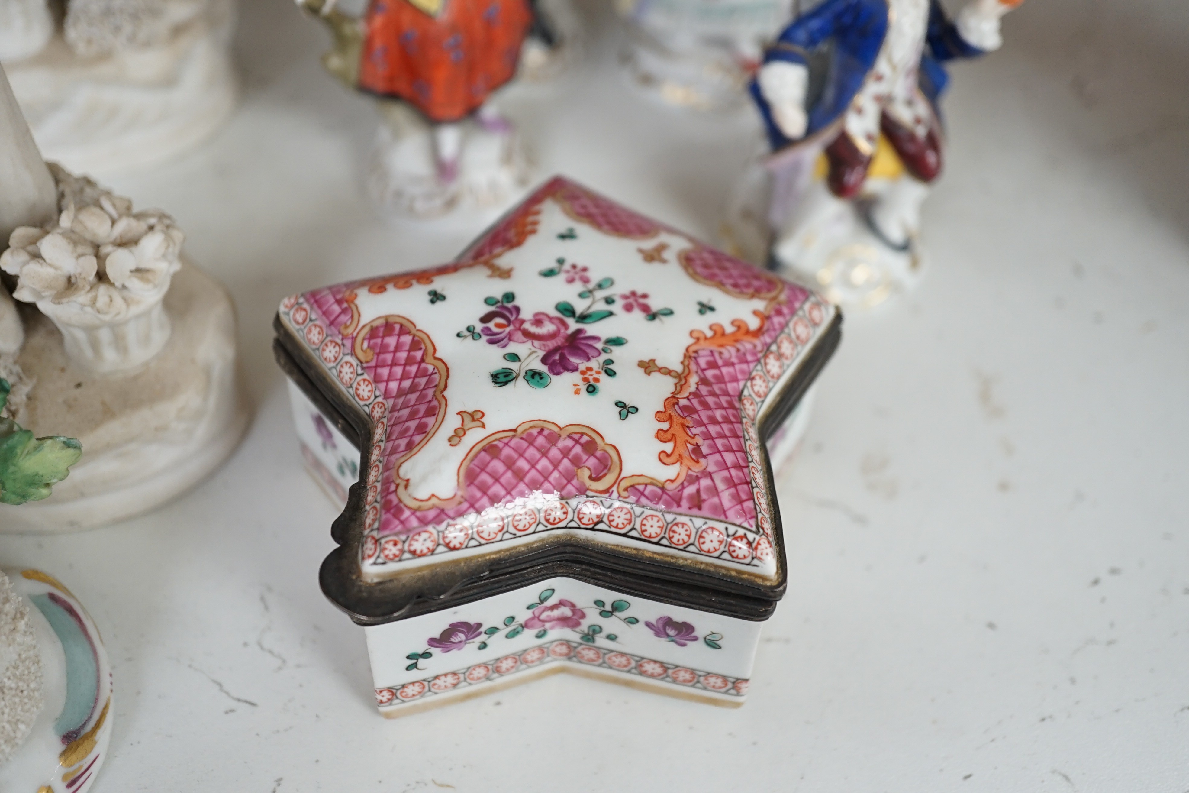 A pair of Hochst porcelain models of cows, 10.5cm long, a lidded box and other Continental figures